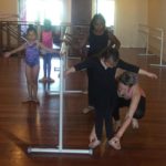 a dance instructor teaching children